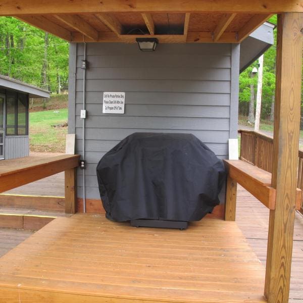 wooden terrace featuring a grill