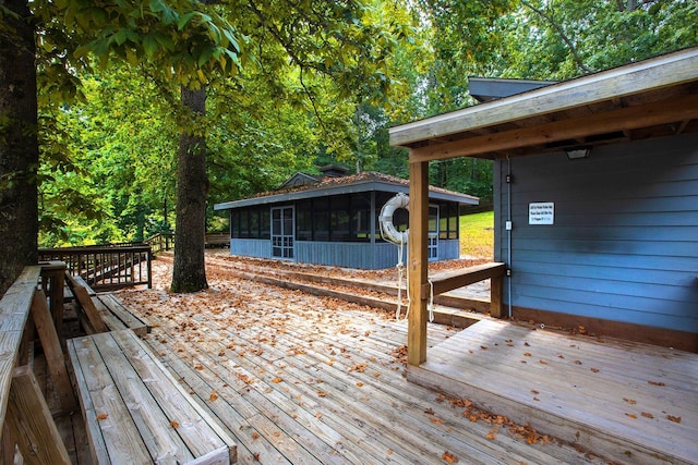 wooden deck with a sunroom