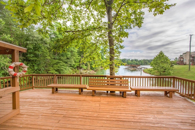 wooden terrace featuring a water view