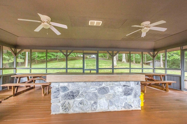 sunroom / solarium featuring visible vents and a ceiling fan