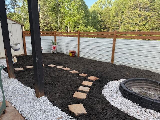 100 Surber Dr, Moneta, VA 24121 - fenced yard with a fire pit and a forest view