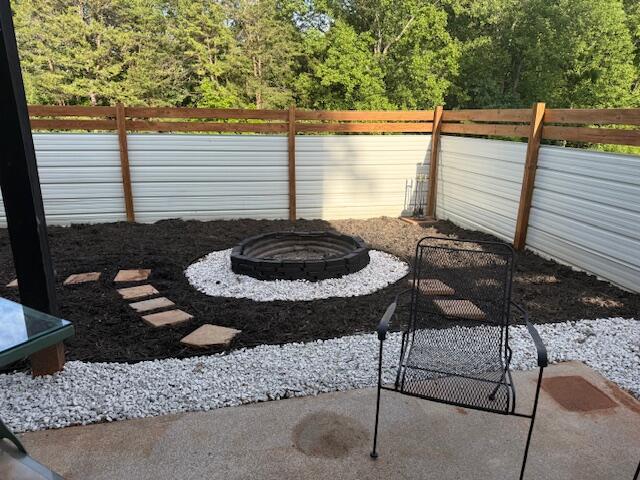 100 Surber Dr, Moneta, VA 24121 - view of patio / terrace with an outdoor fire pit, fence, and a wooded view