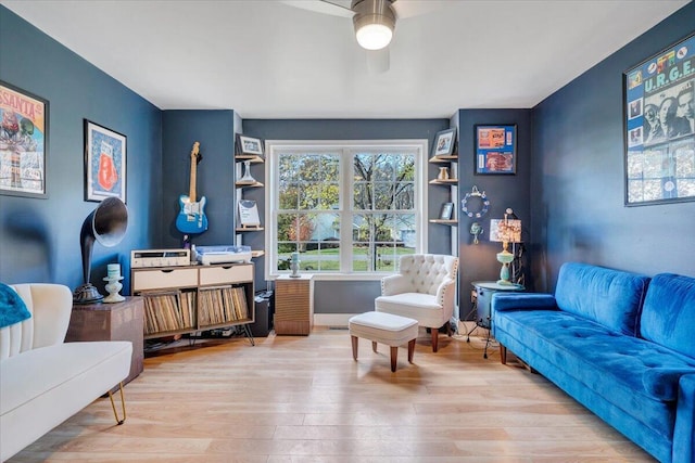 sitting room with ceiling fan and light hardwood / wood-style floors