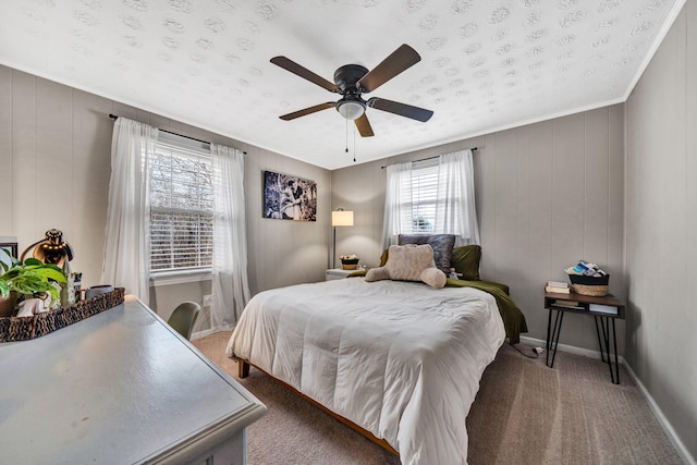 bedroom featuring carpet floors, ceiling fan, crown molding, and wooden walls