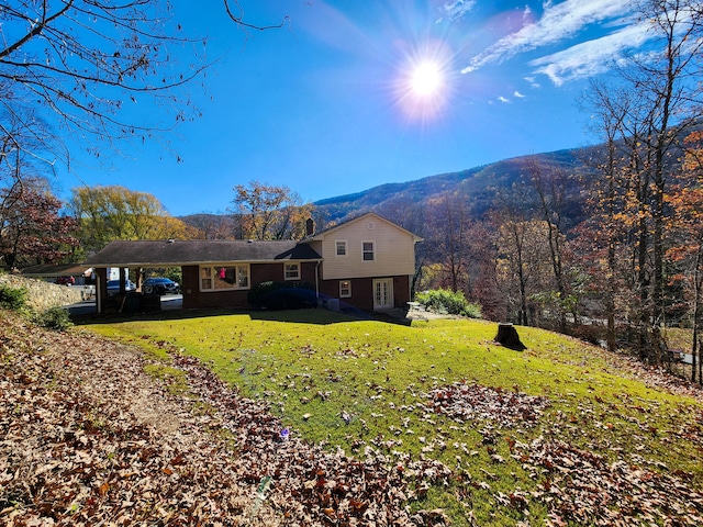 exterior space with a mountain view and a yard