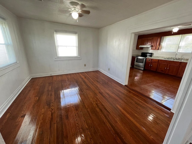 unfurnished dining area with dark hardwood / wood-style floors, sink, and ceiling fan