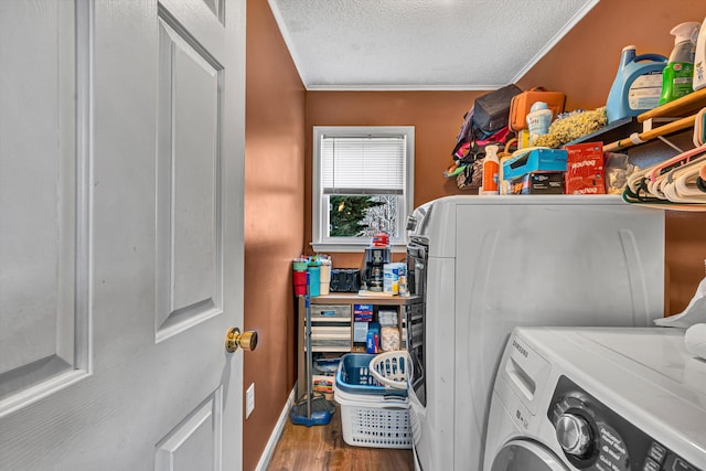 washroom featuring independent washer and dryer, ornamental molding, a textured ceiling, wood finished floors, and laundry area