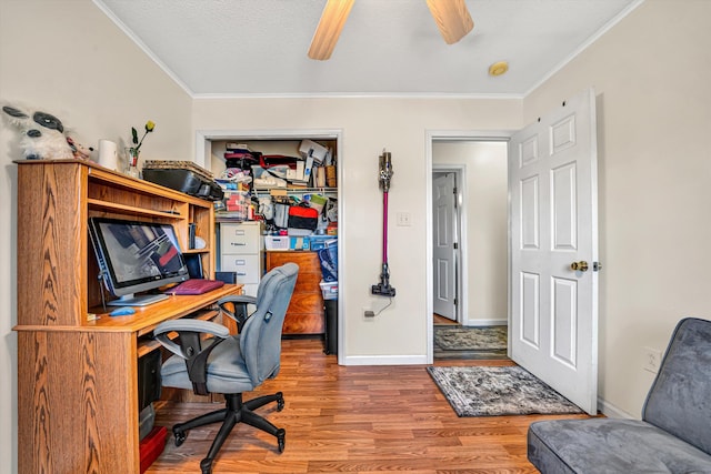 office area featuring crown molding, ceiling fan, baseboards, wood finished floors, and a textured ceiling