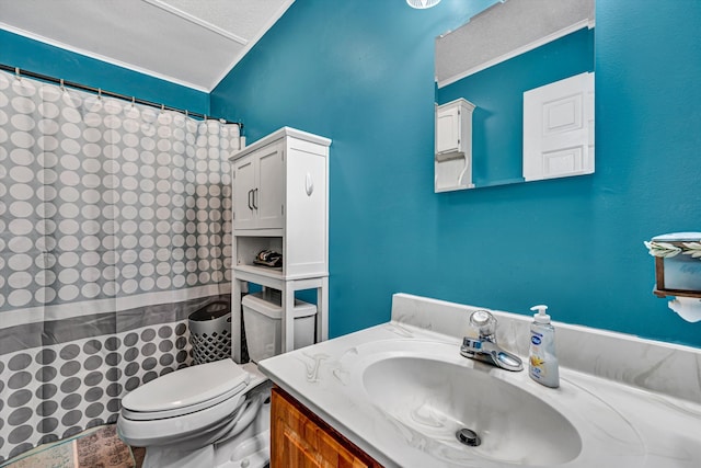 full bathroom featuring curtained shower, toilet, vanity, ornamental molding, and a textured ceiling