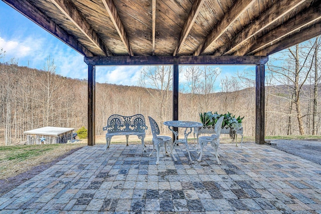 view of patio with a wooded view