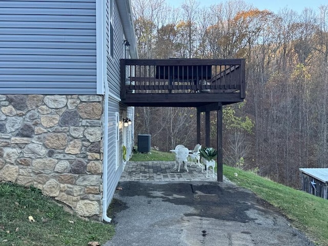 exterior space featuring a deck and cooling unit