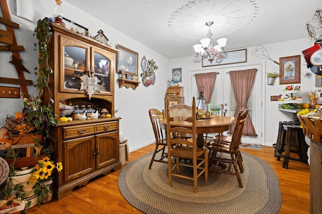 4348 Stewartsville Rd, Moneta, VA 24121 - dining room featuring hardwood / wood-style flooring, a chandelier, and french doors