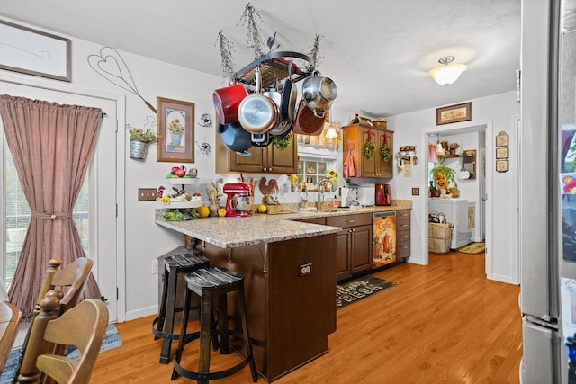 4348 Stewartsville Rd, Moneta, VA 24121 - kitchen with a kitchen breakfast bar, light hardwood / wood-style floors, washer / dryer, and a wealth of natural light