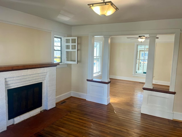 unfurnished living room with a fireplace, wood-type flooring, and ceiling fan