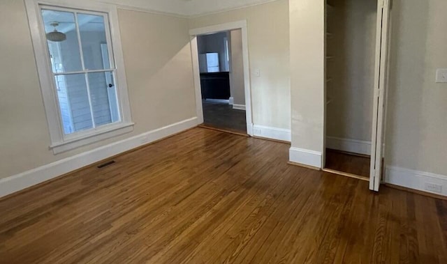 unfurnished room with dark hardwood / wood-style floors