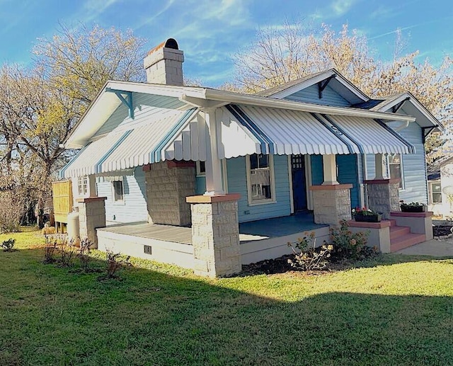 view of front of home with a porch and a front yard