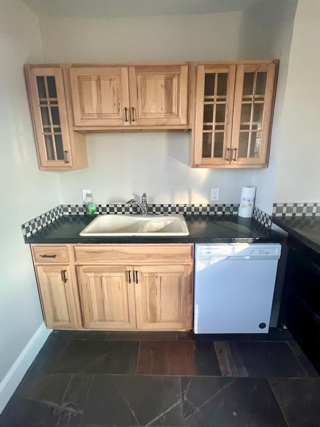 kitchen with dishwasher, light brown cabinetry, and sink