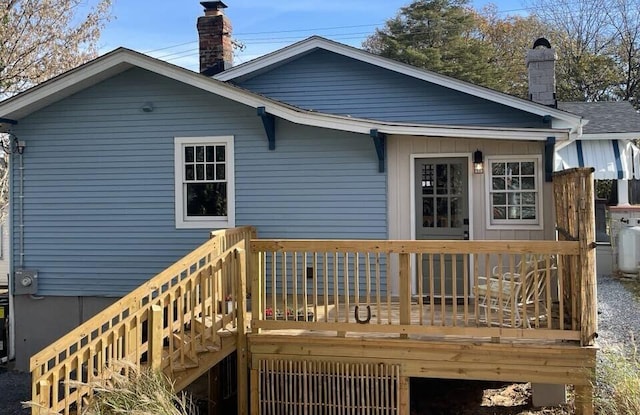 rear view of property with a wooden deck