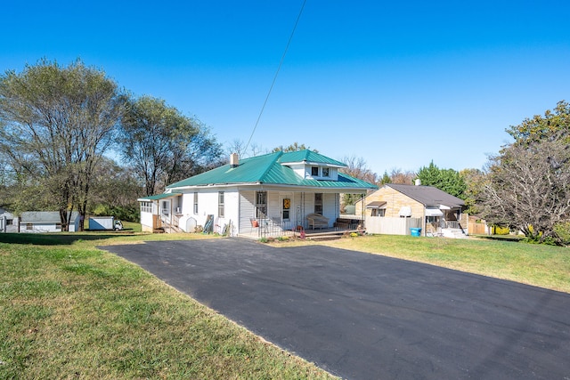 view of front of property with a porch and a front lawn