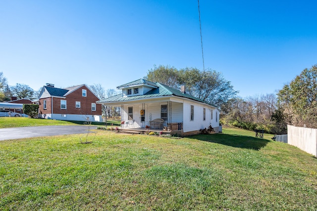 bungalow-style house featuring a porch and a front lawn