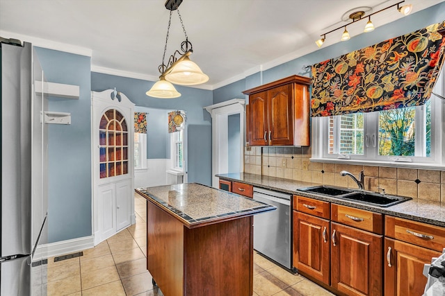 kitchen with tasteful backsplash, a center island, ornamental molding, and appliances with stainless steel finishes