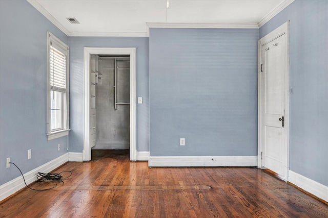 unfurnished bedroom featuring ornamental molding and dark wood-type flooring