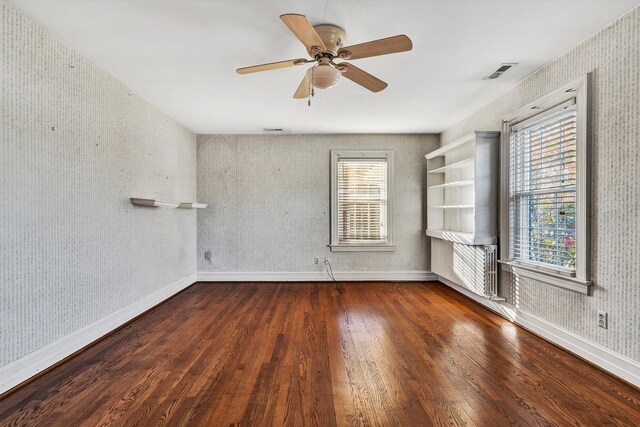 spare room with ceiling fan and dark hardwood / wood-style flooring