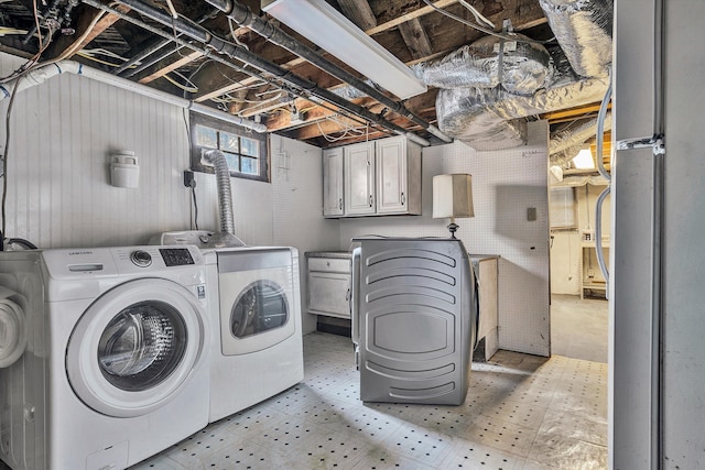 washroom featuring washer and dryer and cabinets