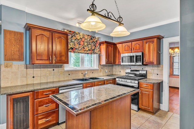 kitchen with sink, a center island, crown molding, and appliances with stainless steel finishes