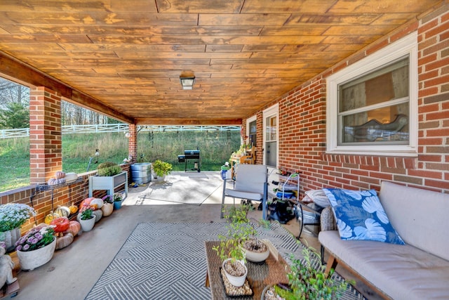 view of patio with area for grilling and an outdoor hangout area