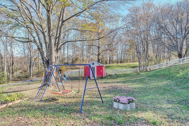 view of yard with a storage shed and a playground