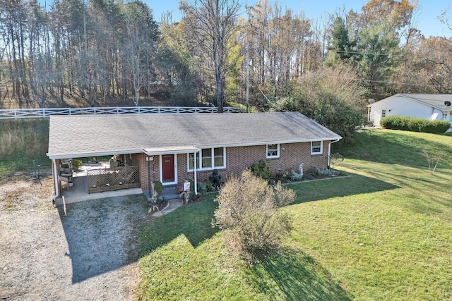 ranch-style home with a carport and a front yard