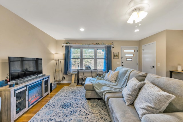 living room featuring hardwood / wood-style floors and ceiling fan