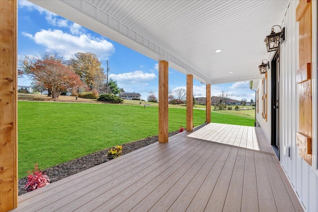 wooden deck featuring a yard