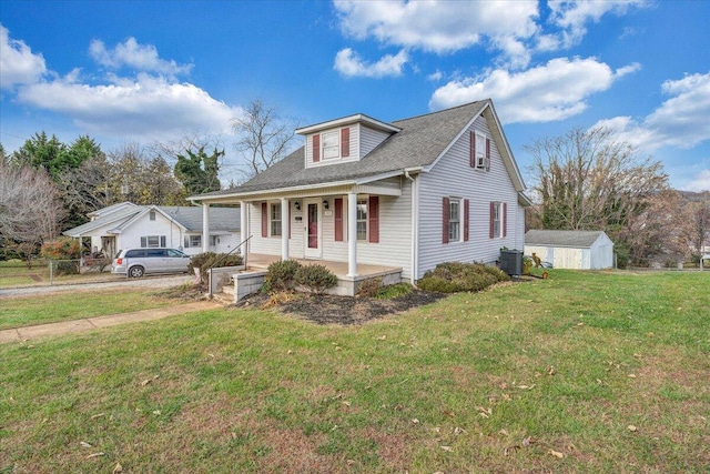 view of front of home with a front lawn, covered porch, and central AC unit