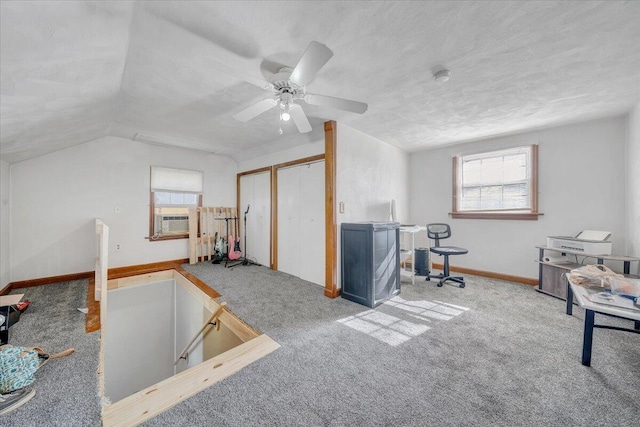 rec room with carpet flooring, ceiling fan, a healthy amount of sunlight, and vaulted ceiling