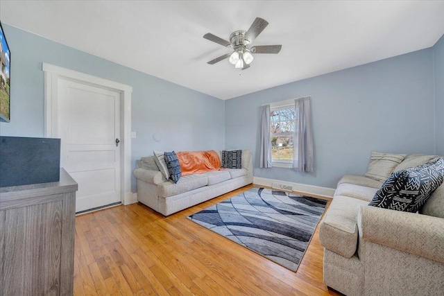 living room featuring ceiling fan and light hardwood / wood-style floors