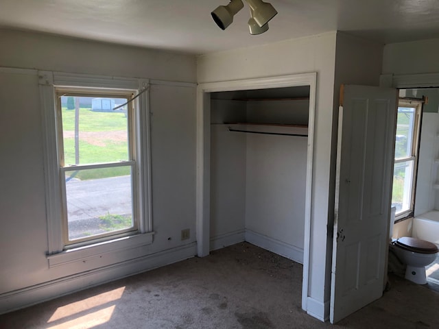 unfurnished bedroom with ceiling fan, a closet, and carpet