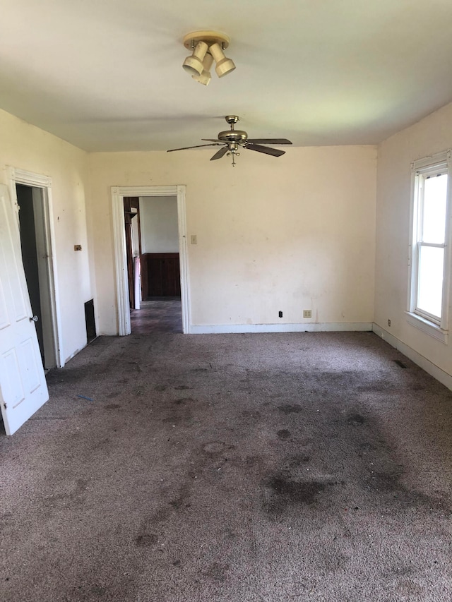 carpeted empty room with ceiling fan