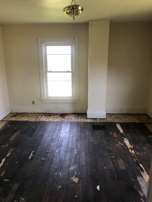 unfurnished room with dark hardwood / wood-style flooring