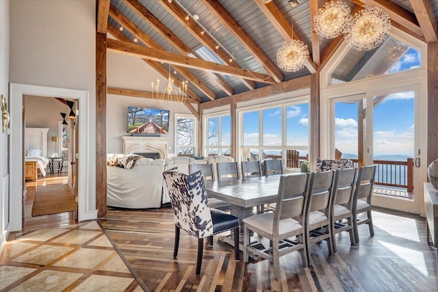 dining space with beamed ceiling, hardwood / wood-style flooring, high vaulted ceiling, and a notable chandelier