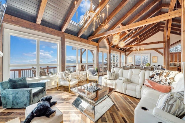 sunroom with vaulted ceiling with beams, wooden ceiling, a water view, and a chandelier