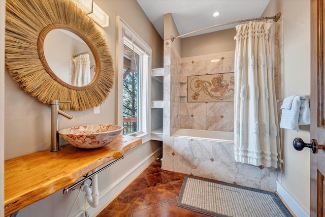 bathroom featuring tile patterned floors, sink, and shower / tub combo