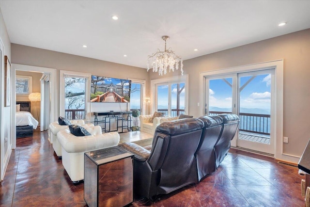 living room featuring an inviting chandelier and a healthy amount of sunlight