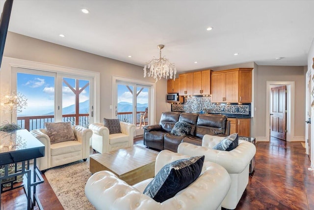 living room featuring a mountain view and an inviting chandelier