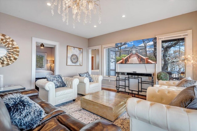 living room featuring light hardwood / wood-style flooring and an inviting chandelier