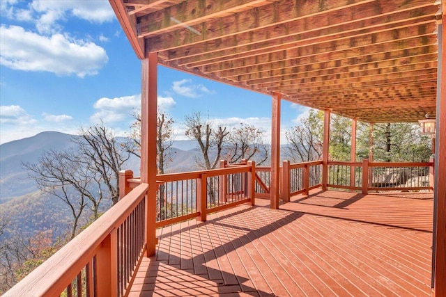 wooden deck with a mountain view