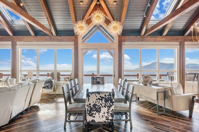 dining room featuring a mountain view, beam ceiling, dark hardwood / wood-style floors, and high vaulted ceiling