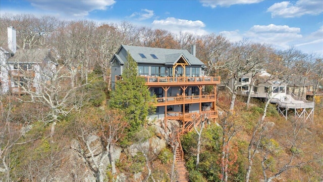 rear view of property featuring a wooden deck