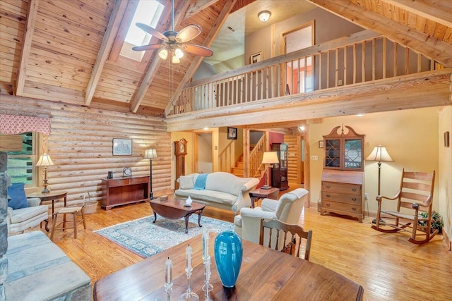 living room with wood ceiling, ceiling fan, hardwood / wood-style flooring, and beamed ceiling